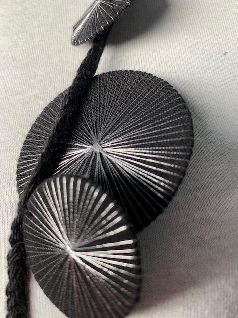 Black discs on fabric braid chain